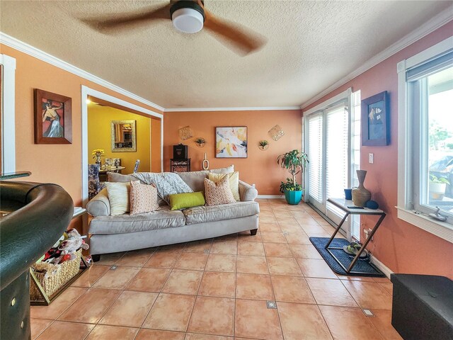 tiled living room featuring a textured ceiling, crown molding, and ceiling fan