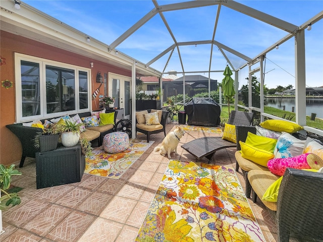 sunroom featuring a water view