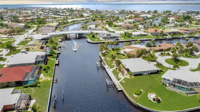 birds eye view of property with a residential view and a water view