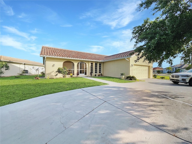 mediterranean / spanish house with stucco siding, a tiled roof, an attached garage, and a front lawn