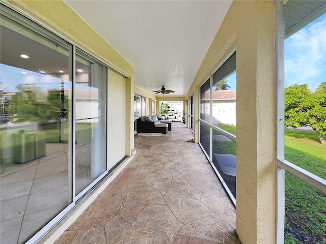 sunroom / solarium featuring ceiling fan