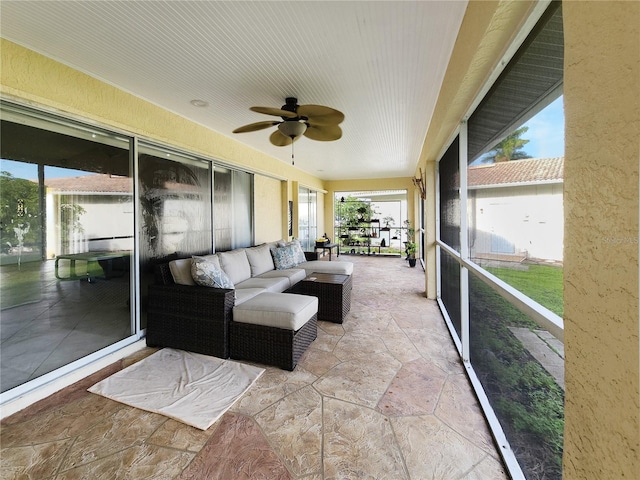 sunroom / solarium featuring ceiling fan