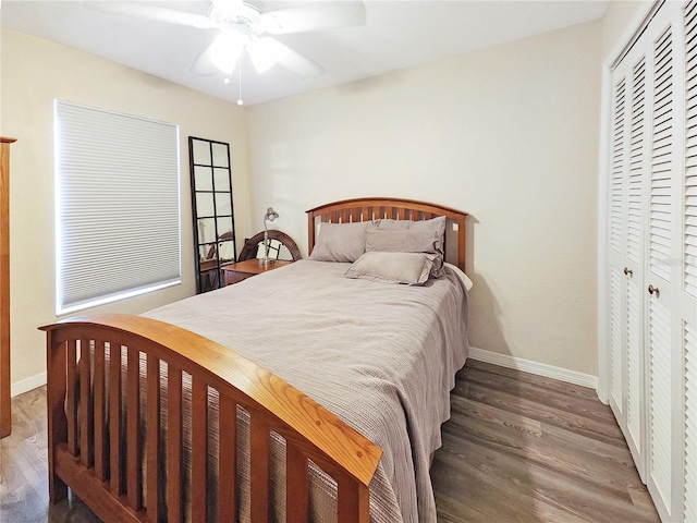 bedroom with dark hardwood / wood-style flooring, a closet, and ceiling fan