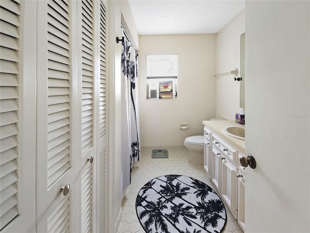 bathroom featuring vanity, tile patterned flooring, and toilet