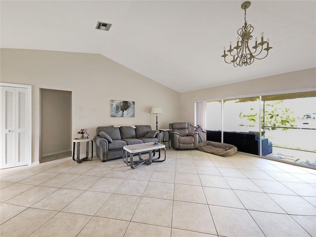 living room featuring a notable chandelier, lofted ceiling, and light tile patterned floors