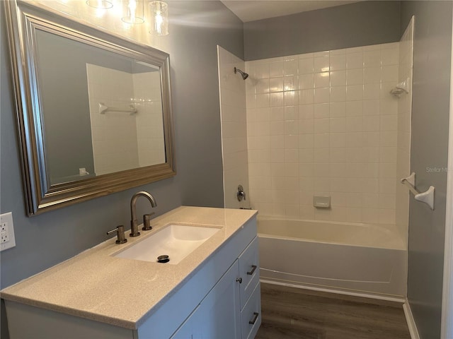 bathroom featuring vanity, hardwood / wood-style floors, and tiled shower / bath combo