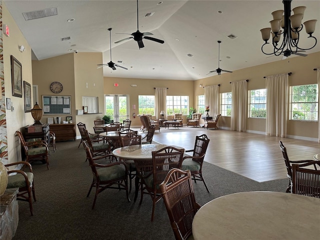 dining room featuring a notable chandelier, hardwood / wood-style flooring, and high vaulted ceiling