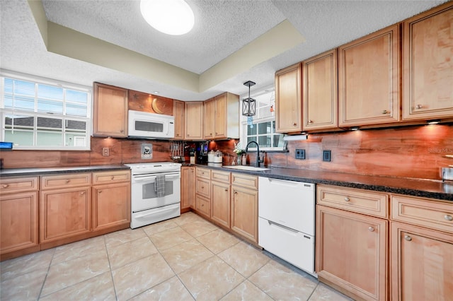 kitchen featuring sink, a textured ceiling, white appliances, and light tile patterned floors