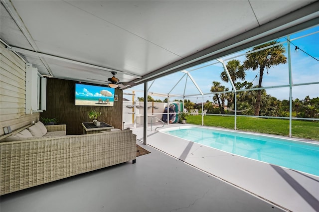 view of swimming pool with a lanai, a patio area, outdoor lounge area, and ceiling fan