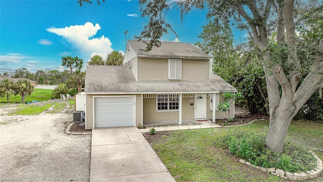 view of front of home featuring a garage, a front lawn, covered porch, and central air condition unit