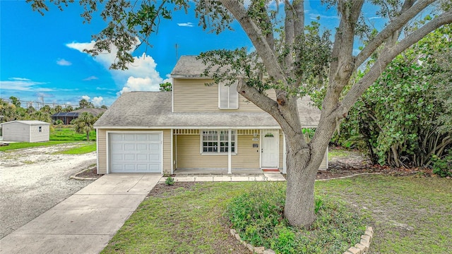 view of front of house featuring a garage, a front lawn, and covered porch