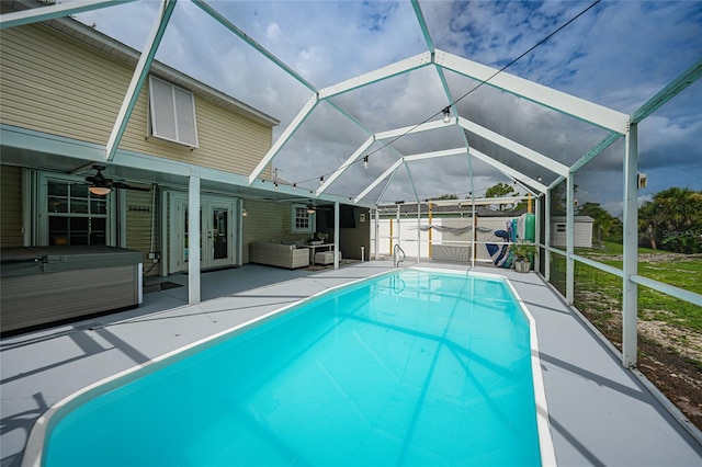 view of pool with a patio area, a hot tub, glass enclosure, ceiling fan, and an outdoor living space