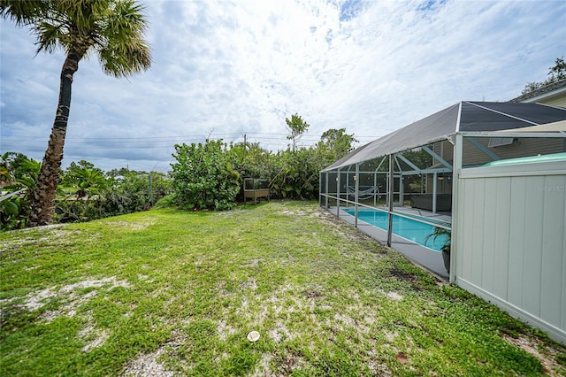 view of yard with glass enclosure