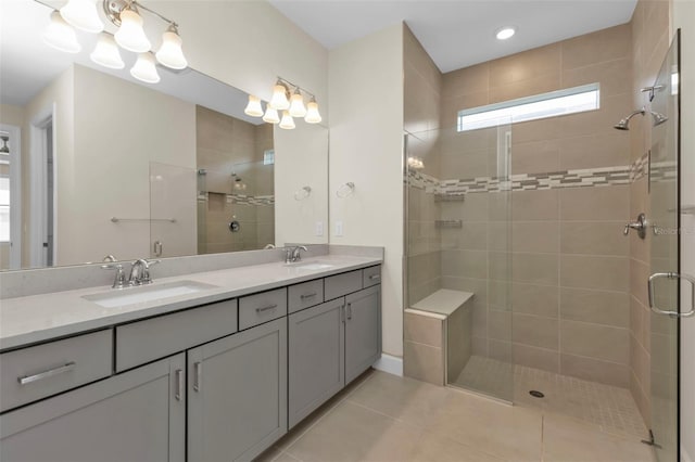 bathroom with tile patterned floors, an enclosed shower, and vanity