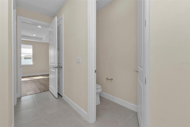 bathroom with toilet and tile patterned flooring