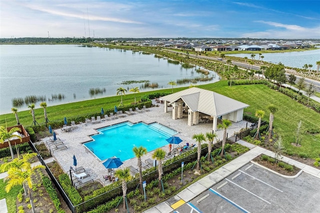 view of pool with a water view and a patio area