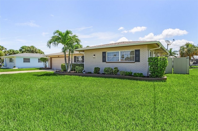 ranch-style house with a garage and a front yard