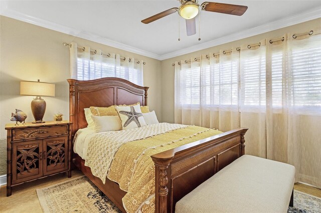 tiled bedroom with ceiling fan, multiple windows, and crown molding