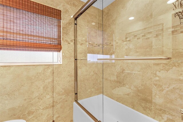 bathroom featuring shower / bath combination with glass door