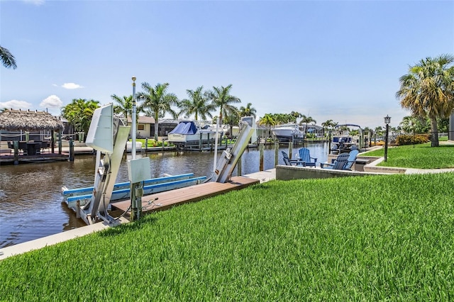 dock area with a water view and a yard