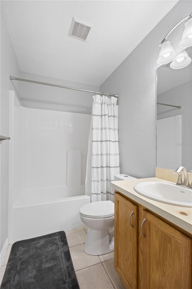 full bathroom with tile patterned floors, vanity, shower / tub combo, and toilet