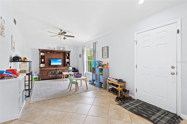 tiled living room with ceiling fan