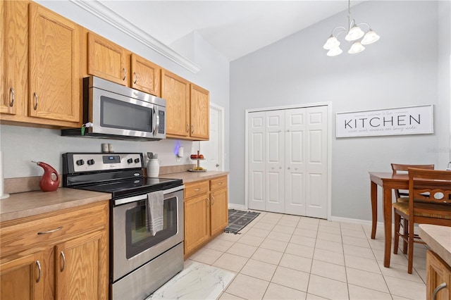 kitchen featuring appliances with stainless steel finishes, light tile patterned floors, an inviting chandelier, and pendant lighting