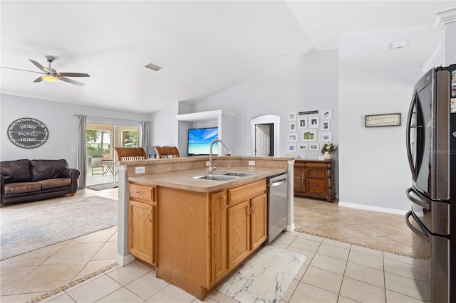 kitchen featuring a center island with sink, light tile patterned floors, stainless steel appliances, and sink