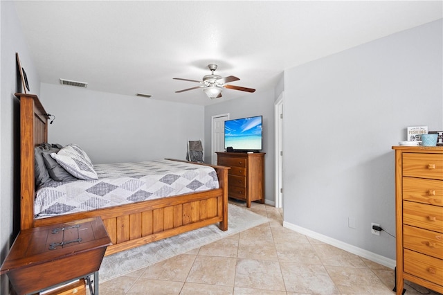 tiled bedroom with ceiling fan