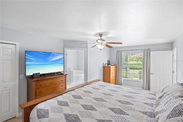 bedroom featuring ceiling fan and a textured ceiling