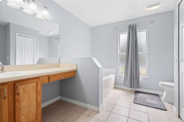 bathroom with toilet, vanity, tile patterned floors, and a wealth of natural light