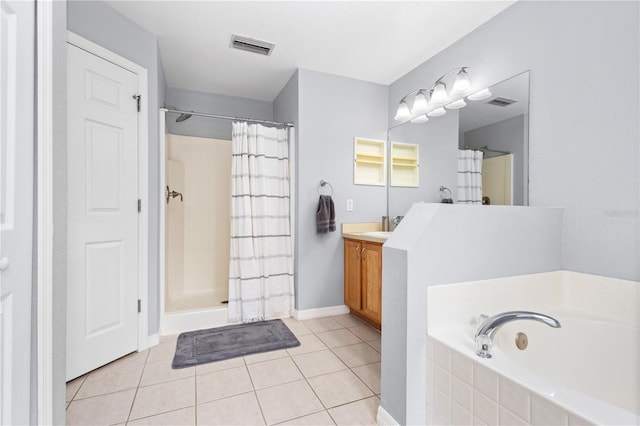 bathroom with vanity, tile patterned floors, and separate shower and tub