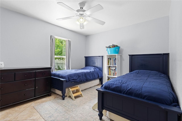 bedroom featuring ceiling fan and light tile patterned flooring