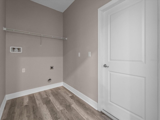 laundry room featuring hookup for a washing machine, hookup for an electric dryer, laundry area, wood finished floors, and baseboards