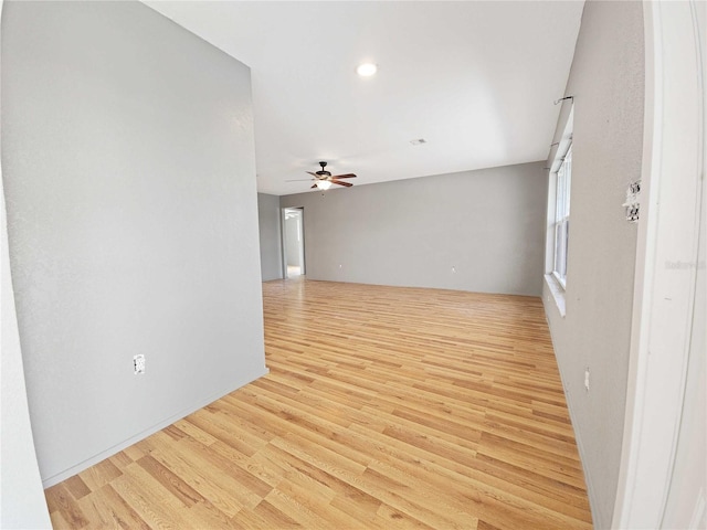 empty room featuring a ceiling fan and light wood-style floors