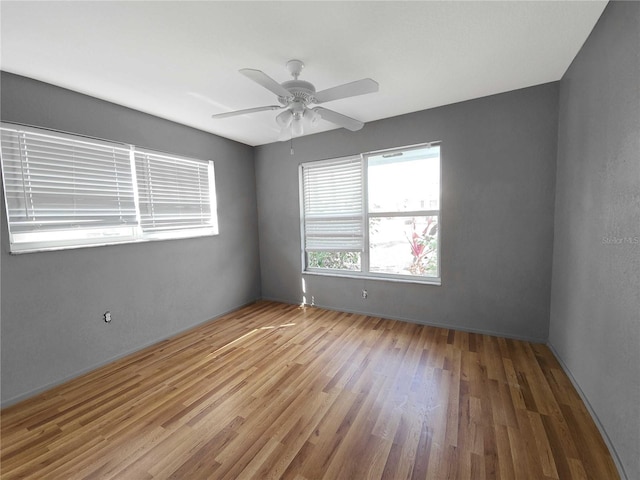 empty room featuring ceiling fan and wood finished floors