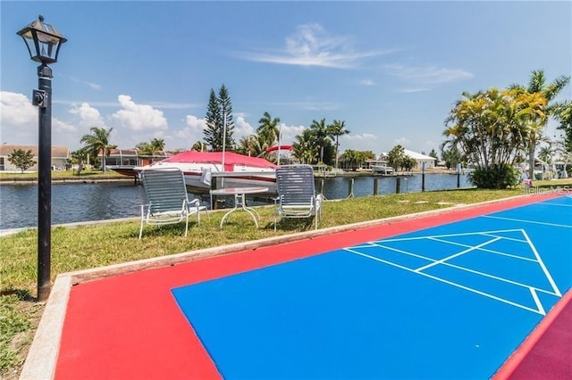 surrounding community with shuffleboard and a water view