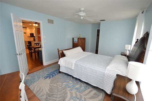 bedroom featuring ceiling fan and dark hardwood / wood-style floors