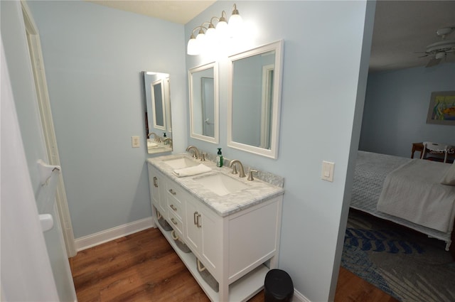 bathroom with ceiling fan, hardwood / wood-style floors, and vanity