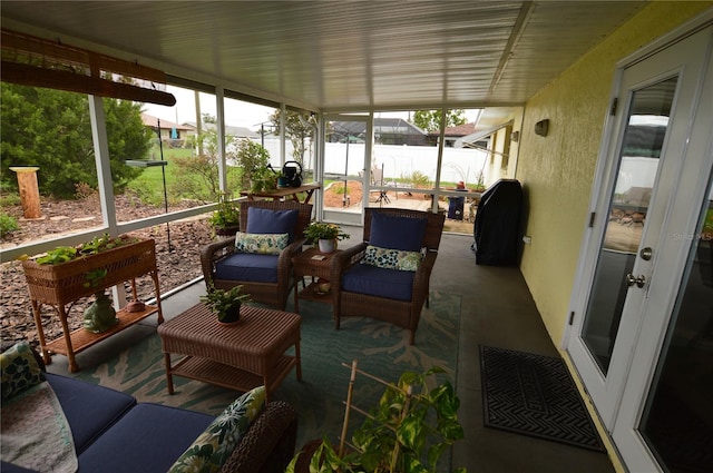 sunroom / solarium featuring a water view