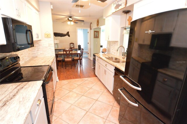 kitchen featuring black appliances, white cabinets, sink, and tasteful backsplash