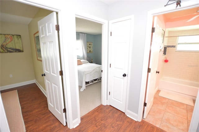 corridor featuring wood-type flooring