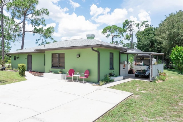 rear view of property featuring a lawn