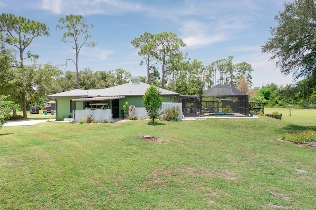 view of yard featuring a lanai and a swimming pool