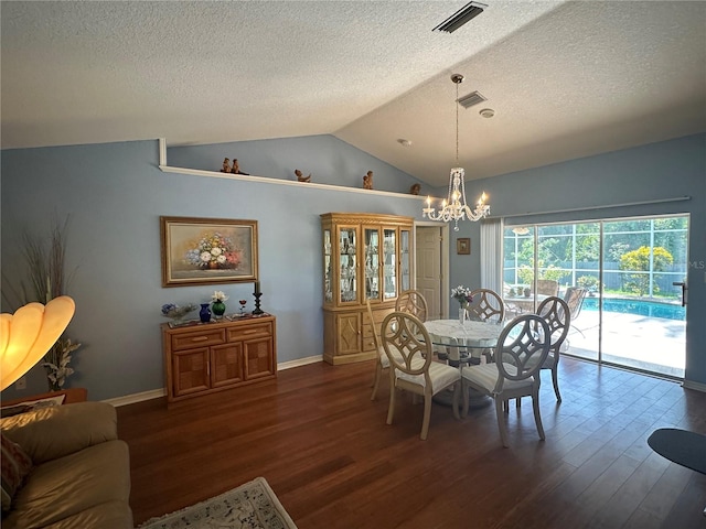 dining room with dark wood-type flooring, lofted ceiling, a chandelier, and a textured ceiling