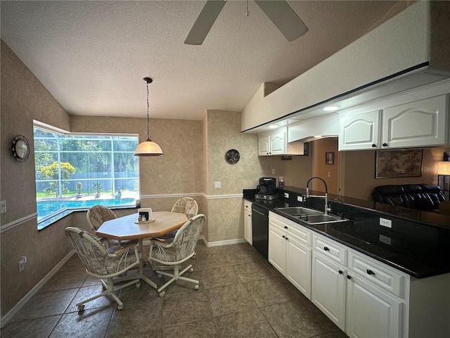 kitchen featuring sink, ceiling fan, dark tile patterned floors, and white cabinetry