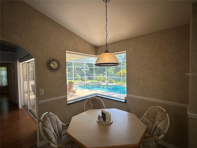 dining area with dark hardwood / wood-style flooring and lofted ceiling