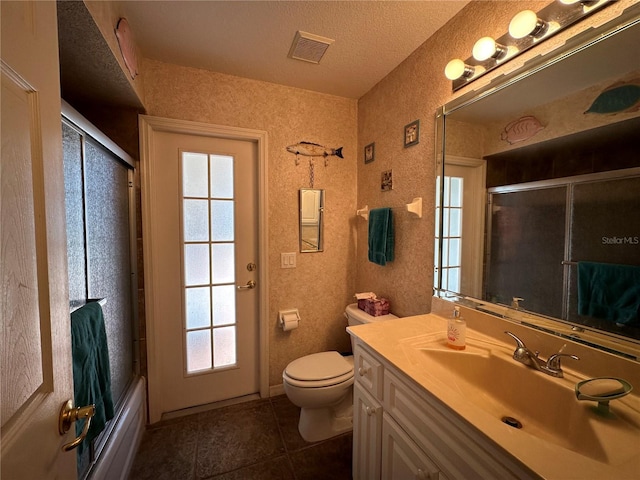 full bathroom with enclosed tub / shower combo, a textured ceiling, tile patterned floors, toilet, and vanity