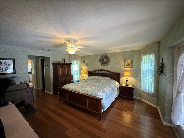 bedroom featuring a textured ceiling, ceiling fan, and dark wood-type flooring