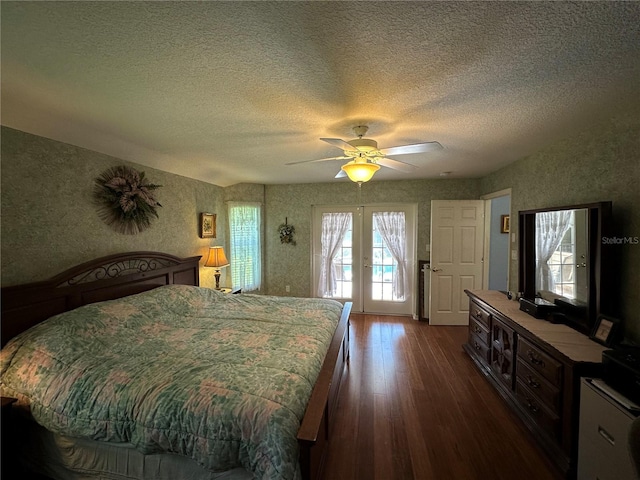 bedroom with ceiling fan, access to outside, french doors, a textured ceiling, and dark wood-type flooring